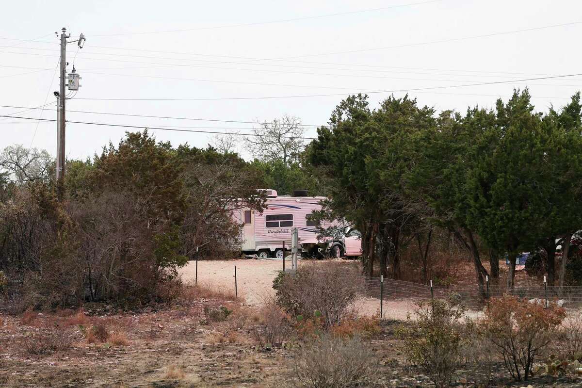 Fire retardant used to fight the Das Goat fire colors an RV and vehicle at a home in the High Mountain Ranch subdivision in Medina Countyon March 29, 2022. The fire consumed over 1,000 acres and started on March 25.