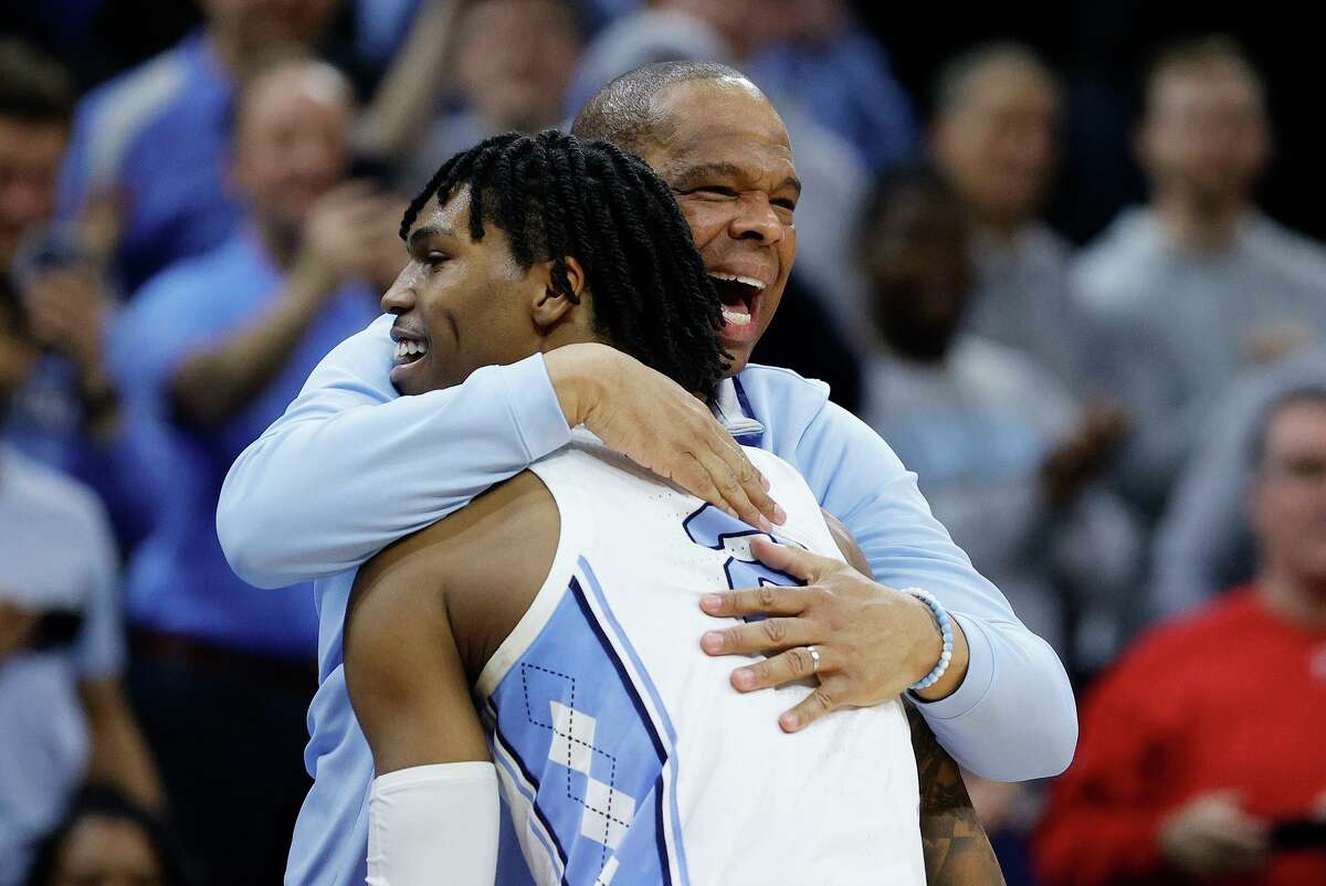 First-year North Carolina head coach Hubert Davis celebrates with guard Caleb Love after the Tar Heels defeated St. Peter’s 69-49 in their Elite Eight game Sunday in Philadelphia.