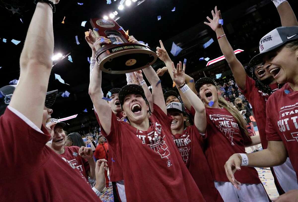 Stanford players hoist the regional trophy after they beat Texas 59-50 in an Elite Eight game Sunday in Spokane, Wash.