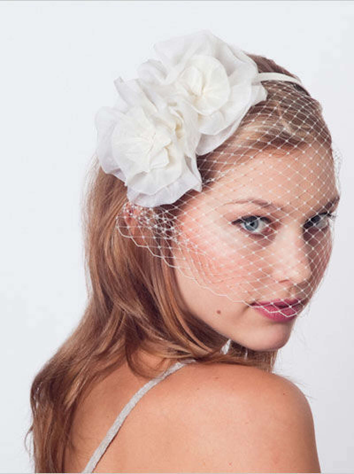 An elegant vintage look with a touch of modern style, the Flower Blossom Birdcage Veil from Jane Tran is affixed to a thin headband for easy wear with long styles. $98, available at Adam Broderick Salon & Spa, Ridgefield