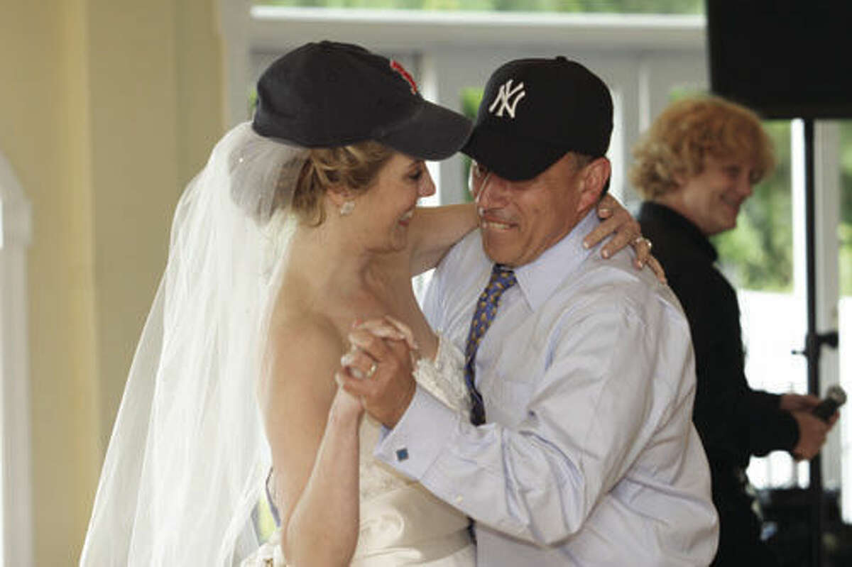Jim and Lisa, wearing caps for their favorite teams, dance to their songs "Take Me Out to the Ball Game" and "At Last."