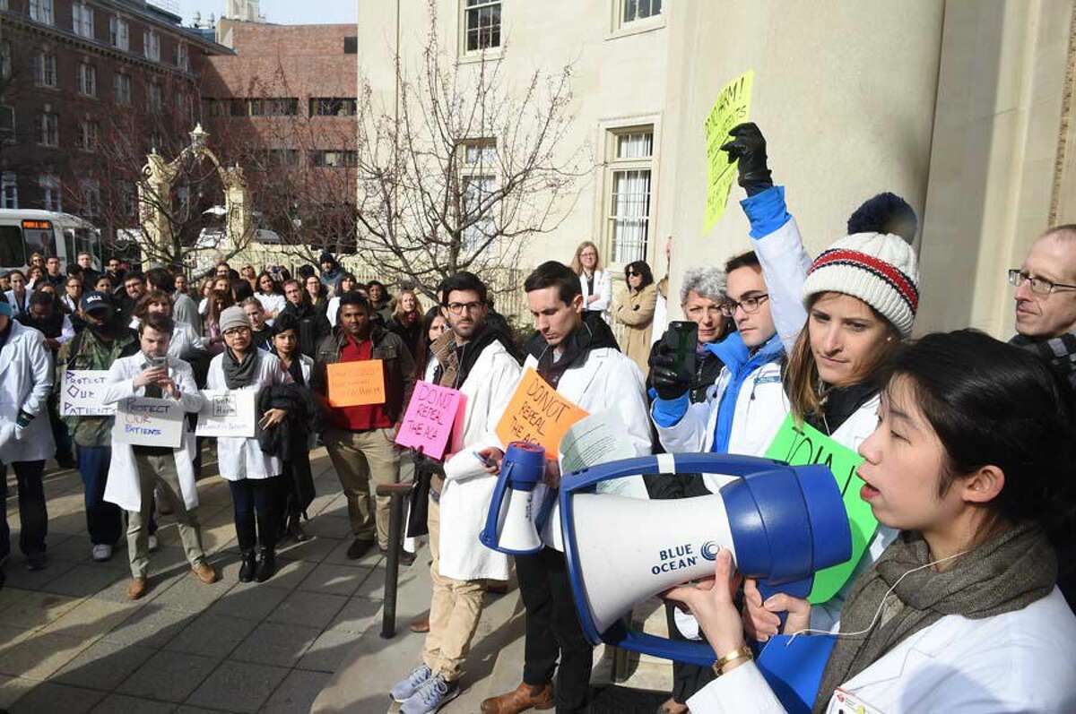 Yale University medical students, faculty, administrators, and others who support the Protect Our Patients movement demonstrate at Yale's Sterling Hall of Medicine in New Haven Connecticut Monday afternoon, January 30 2017 and protest the possibility that millions of Americans may lose their health care coverage if the Affordable Care Act (ACA) is repealed. As part of a national day of action on medical school campuses, students nationwide, are conducting teach-ins, rallies, and public protests to highlight the possible consequences on healthcare if the ACA is repealed.