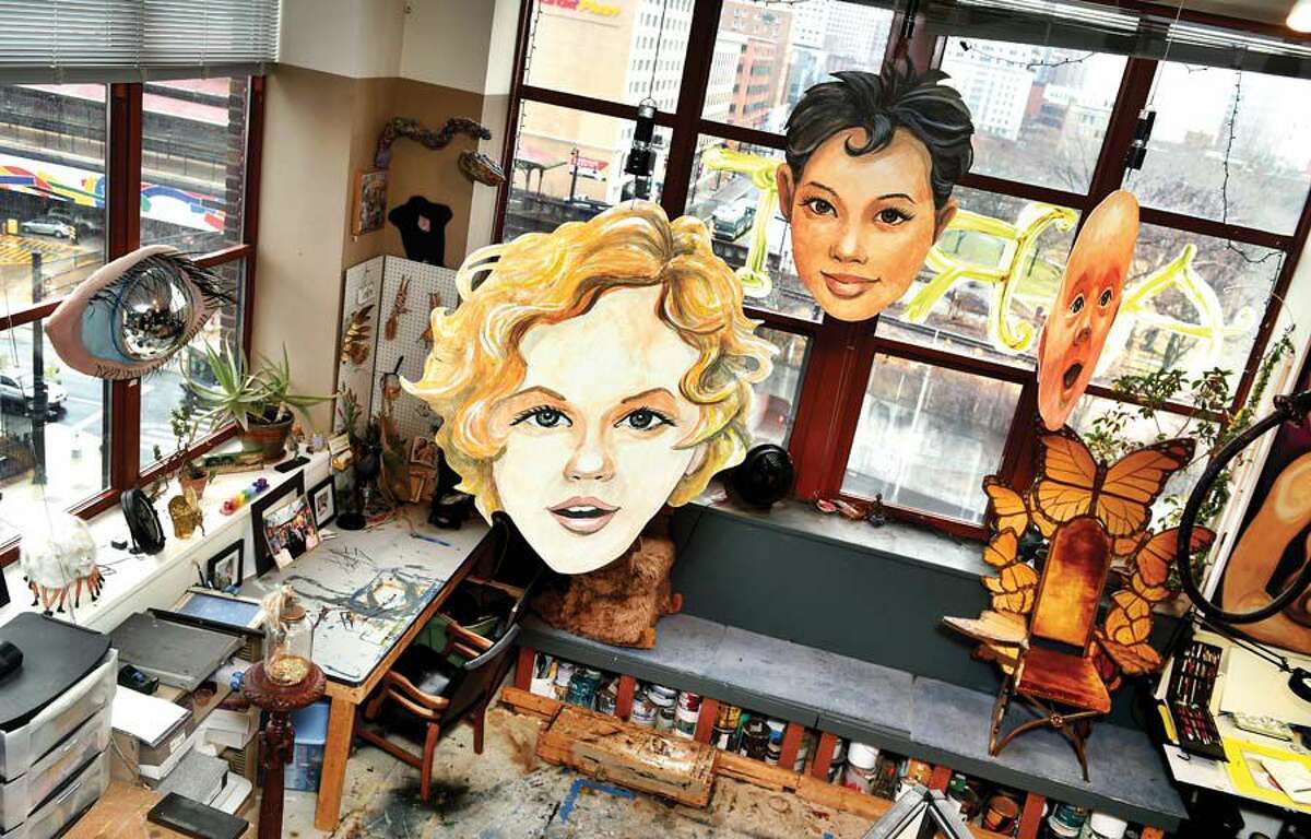 The studio of Tao and Amy LaBossiere in Hartford. Hanging are Tao’s work, Heads of the Family, which are double-sided and feature both male and female faces.