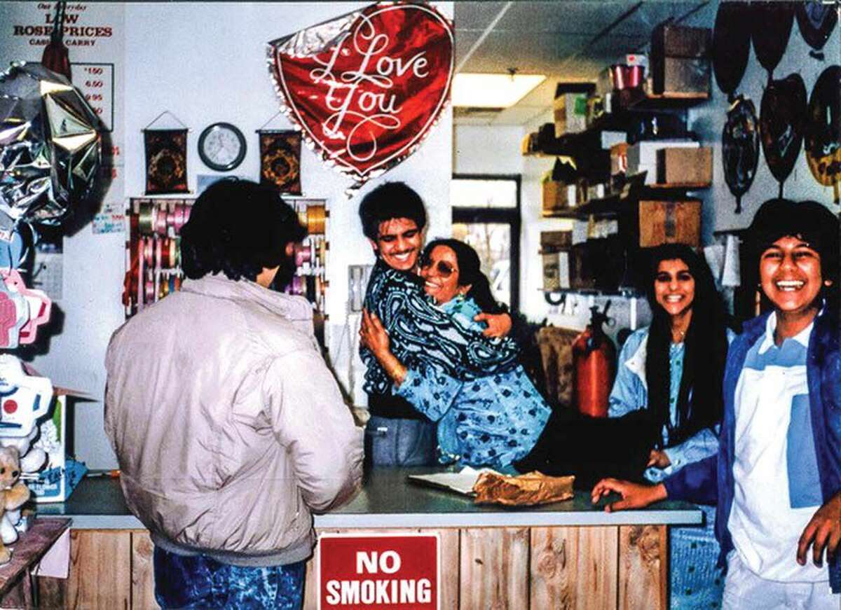 Tariq Farid hugs his mother, Salma, in the family’s East Haven flower shop in the late 1980s.