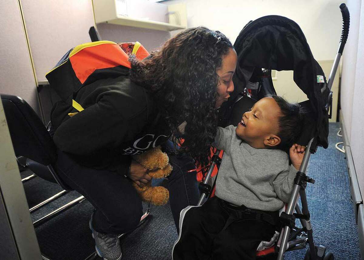 Hurricane refugee Idalis Colon, of Canovanas, Puerto Rico, gives a kiss to her son Leeroy Esquilin, 2, recently at the new Puerto Rico Relief Center at Career Resources Inc. in Bridgeport.