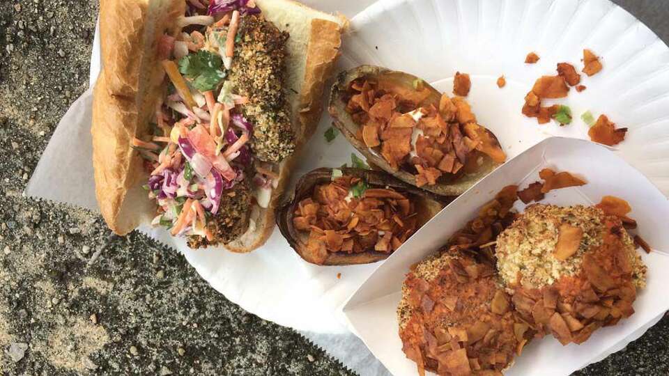 From left, hot Italian 'sausage' and pepper sub, potato skins with 'cheddar, sour cream & bacon' and mac n' cheese balls topped with 'bacon,' from Three Girls Vegan Creamery in Guilford.