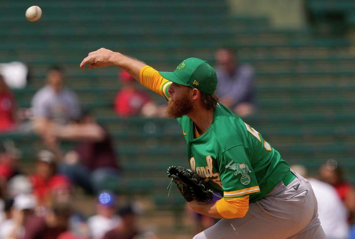 Oakland Athletics starting pitcher Paul Blackburn throws against the Los Angeles Angels during the first inning of a spring training baseball game, Monday, March 28, 2022, in Tempe, Ariz. (AP Photo/Matt York)