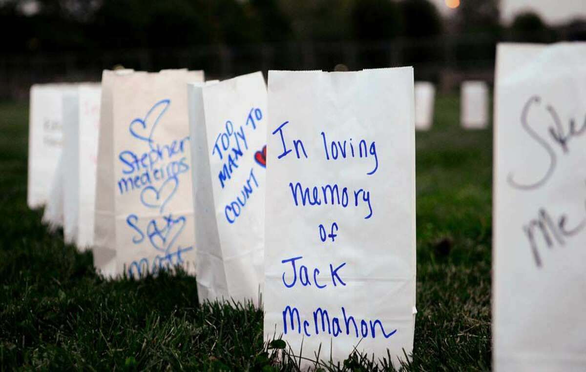 Names adorn paper bags holding a candle to remember victims of opioid addiction before the start of a candle light remembrance service organized by International Overdose Awareness Day-Fight Against Drugs Everywhere (FADE) in Shelton in August 2017.