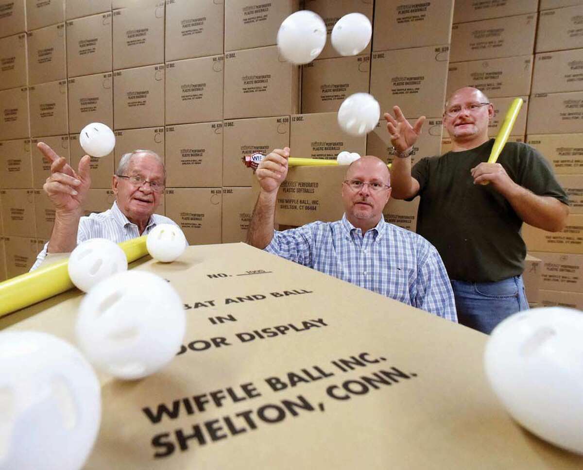 Founder of the Wiffle Ball David A. Mullany, left, and his sons David J. Mullany, center and Stephen Mullany, owners of Wiffle Ball Inc. of Shelton in a company warehouse.