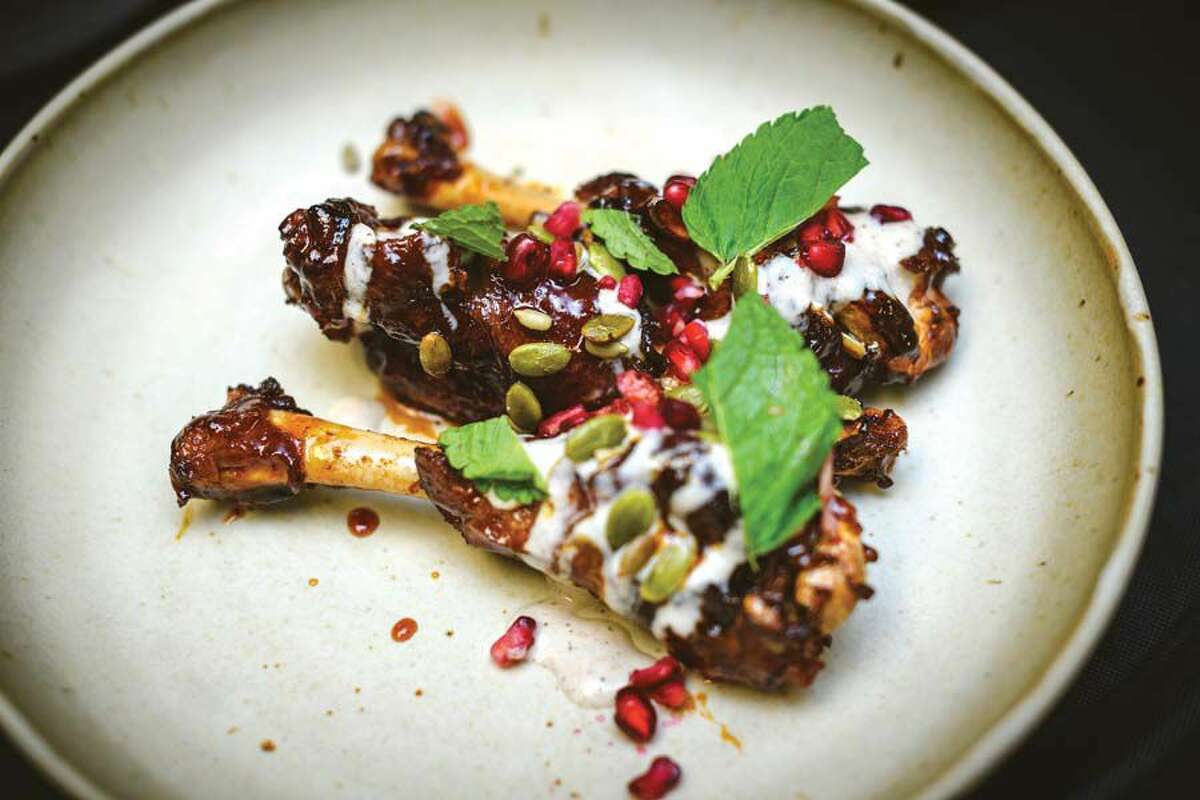 The patas de pato (duck legs), are smoked with a sherry glaze, and served topped with pomegranate seeds.