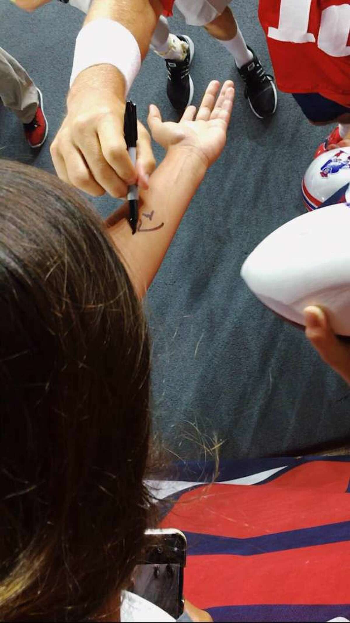 Tom Brady signed the arm of Stratford's Megan Uhrynowski on July 30 at Gillette Stadium in Foxboro, Massachusetts.