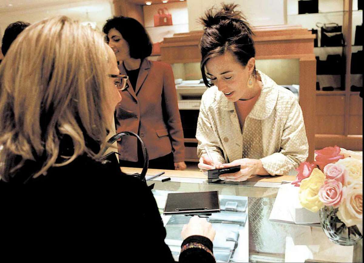 Kate Spade, right, signs one of her products at Saks Fifth Avenue on Greenwich Avenue in 1998.
