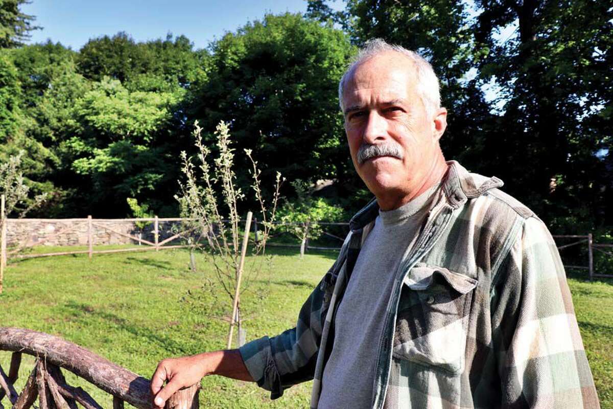 Peter Montgomery on his Warren property with an heirloom apple orchard in the early stages of growth.