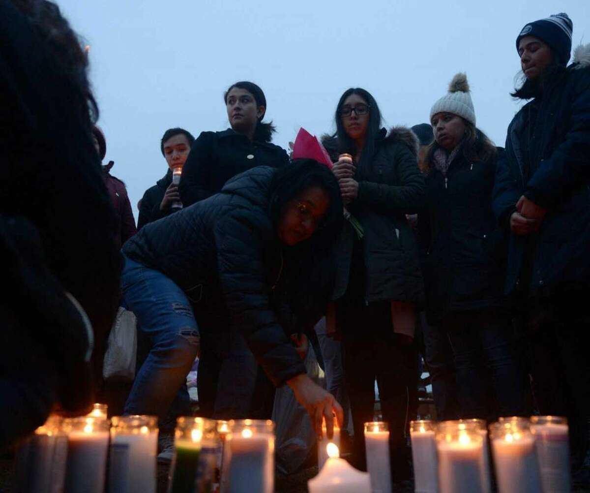 Friends and family grieve for homicide victim Valerie Reyes during a vigil in her honor at Glen Island Park in New Rochelle, N.Y. Thursday, Feb. 7, 2019. Reyes, 24, of New Rochelle, N.Y., was found bound inside of a suitcase just off of Glenville Road in a quiet, wooded area of Greenwich, Conn. on Tuesday morning.