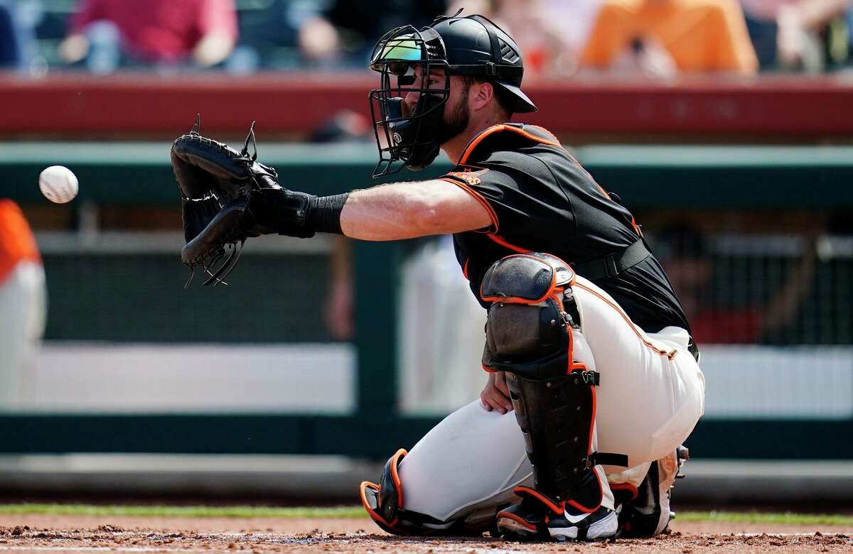 San Francisco Giants catcher Joey Bart reaches out to catch a warm up pitch during the second inning of a spring training baseball game against the Cleveland Guardians Friday, March 25, 2022, in Scottsdale, Ariz. (AP Photo/Ross D. Franklin)