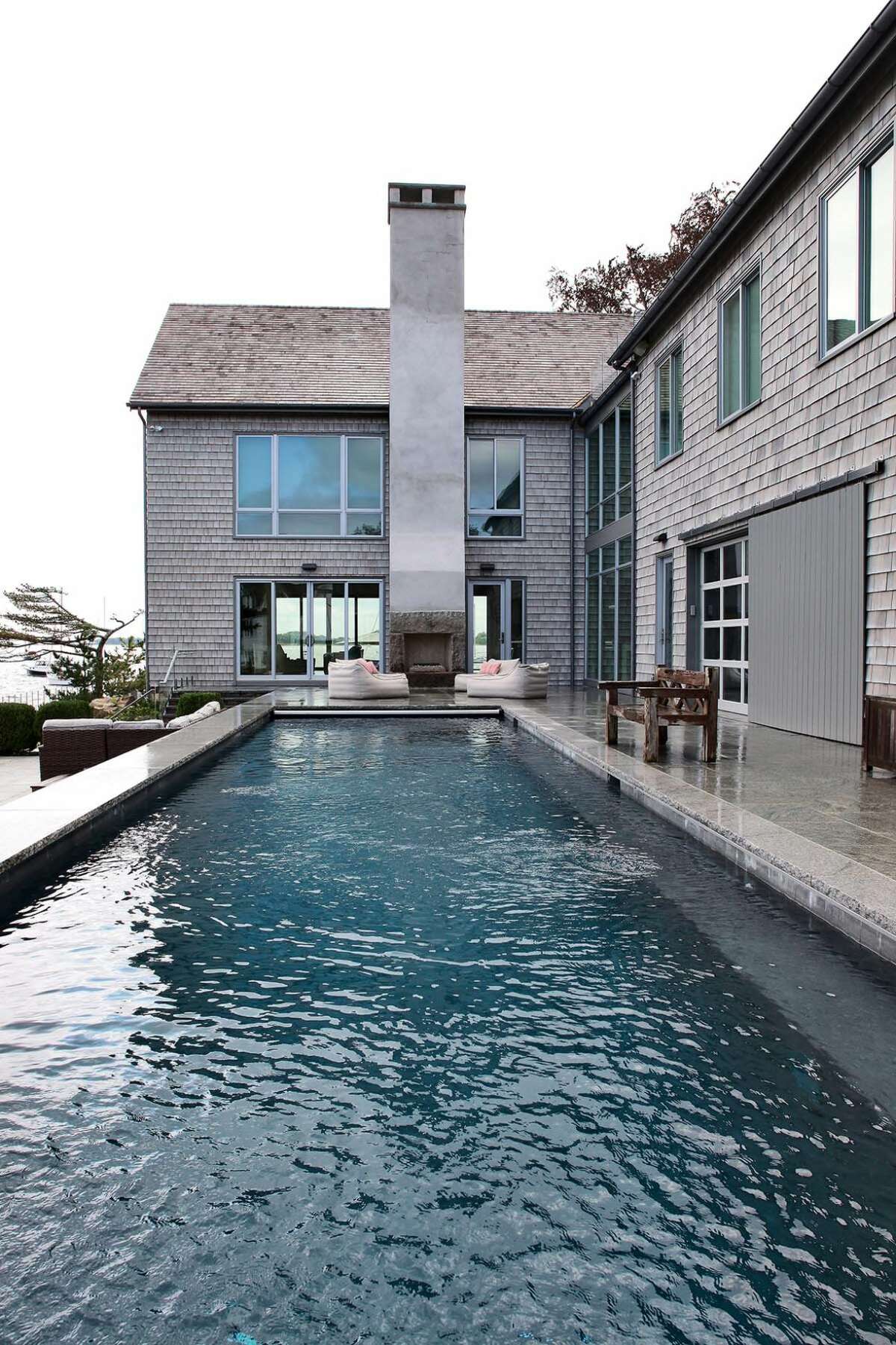 This contemporary coastal compound that sits on a peninsula along Long Island Sound in Rowayton features a spacious great room and plenty of water views through large windows. The house earned the new construction award in the 2019 Alice Washburn residential archiecture contest.