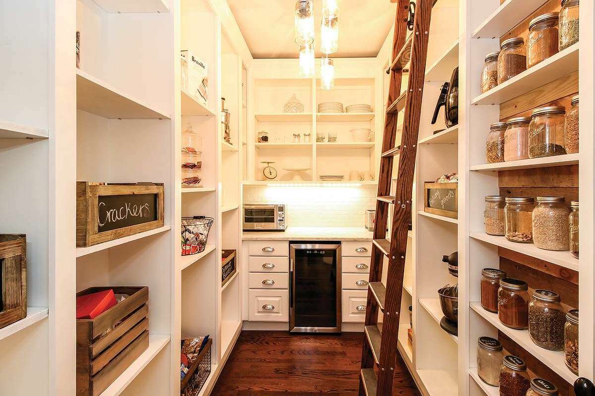 A luxurious walk-in pantry with built-in spaces.