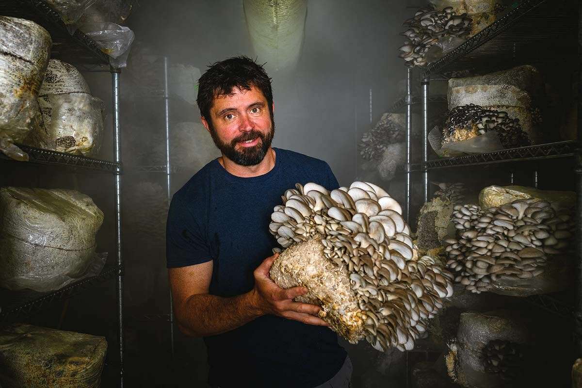 Seacoast Mushrooms owner Chris Pacheco in his climate-controlled, mushroom-growing container in Mystic.
