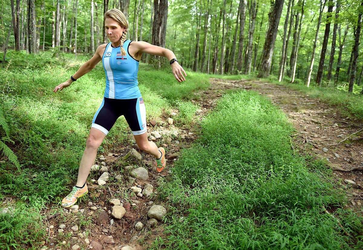Triathlete Laura Becker trains on the trails at Case Mountain in Manchester.