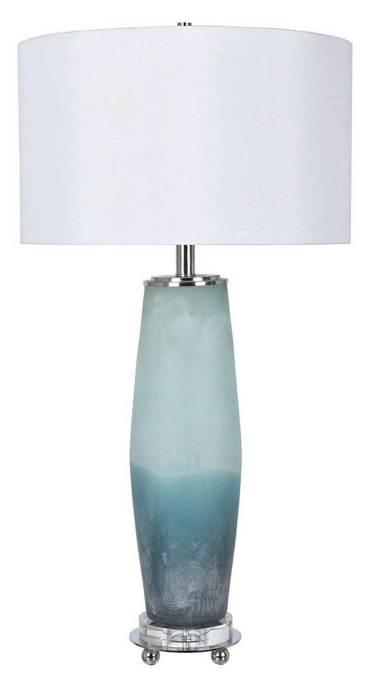 Sea breezes  Seaside table lamp  Highlighted by frosted aquamarines and blues with a sea-glass finish, the lamp has a glass body and sits on a crystal-clear acrylic cylinder. $272.50, Crestview Collection. Mellow Monkey Gifts and Home Decor, Stratford, mellowmonkey.com