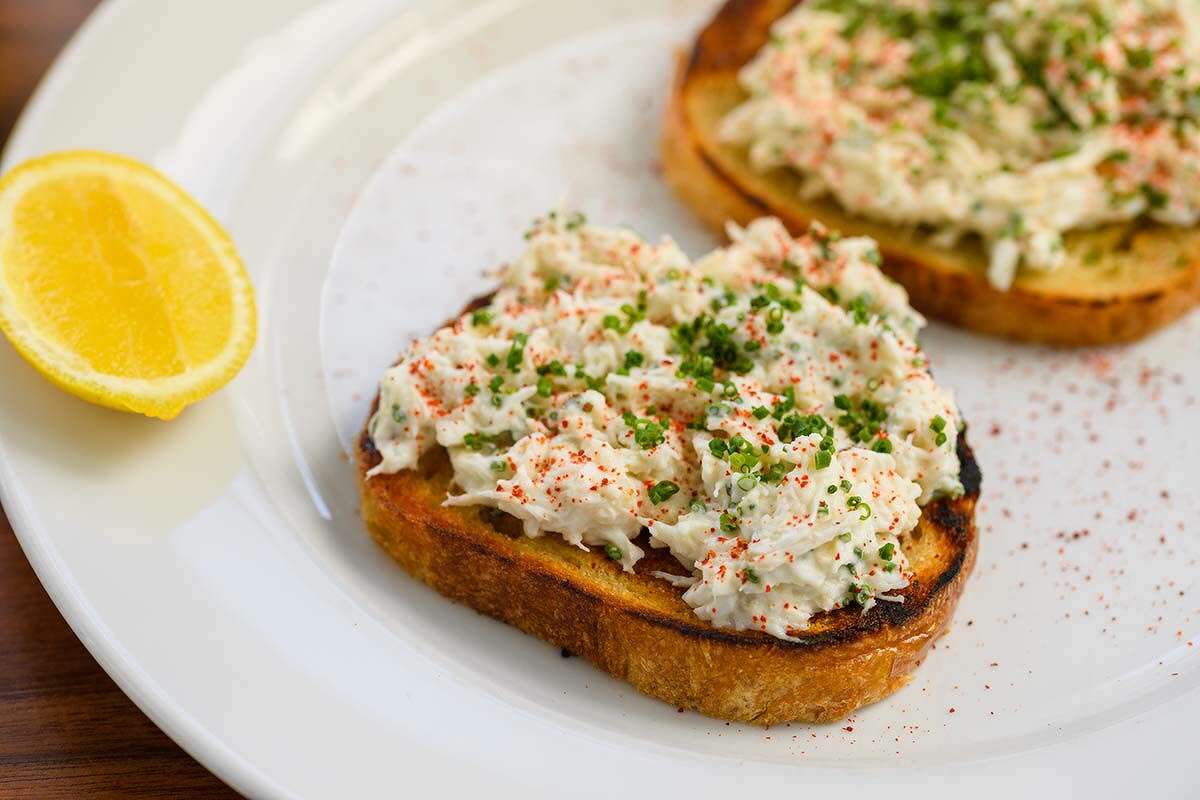 Crab toast with fresh crab, butter, sourdough and chives espellete
