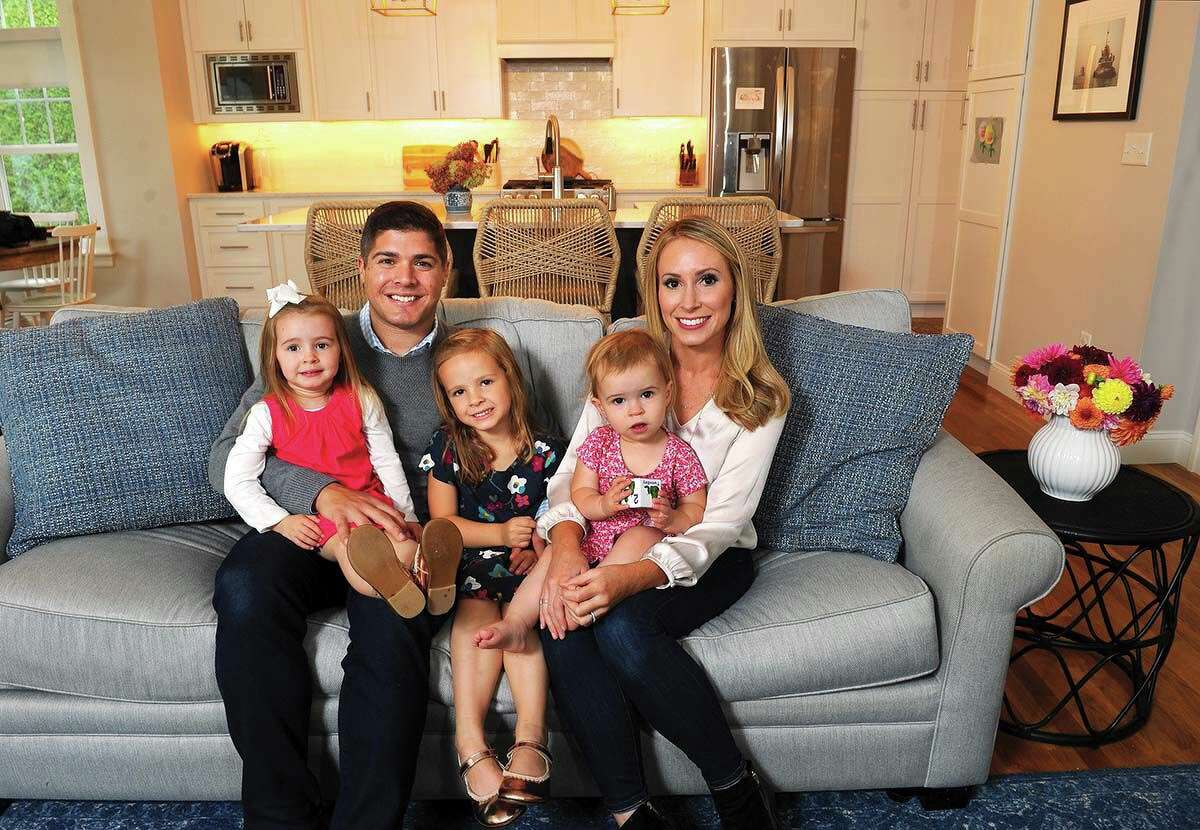The Monteith family, Matt and Stephanie with their daughters, from left, Scarlett, Mae and Caroline, in their recently expanded West Hartford home. The Monteiths renovated the 1920s Dutch Colonial, building a two-story addition with an open living space and a master suite to accommodate their growing family.