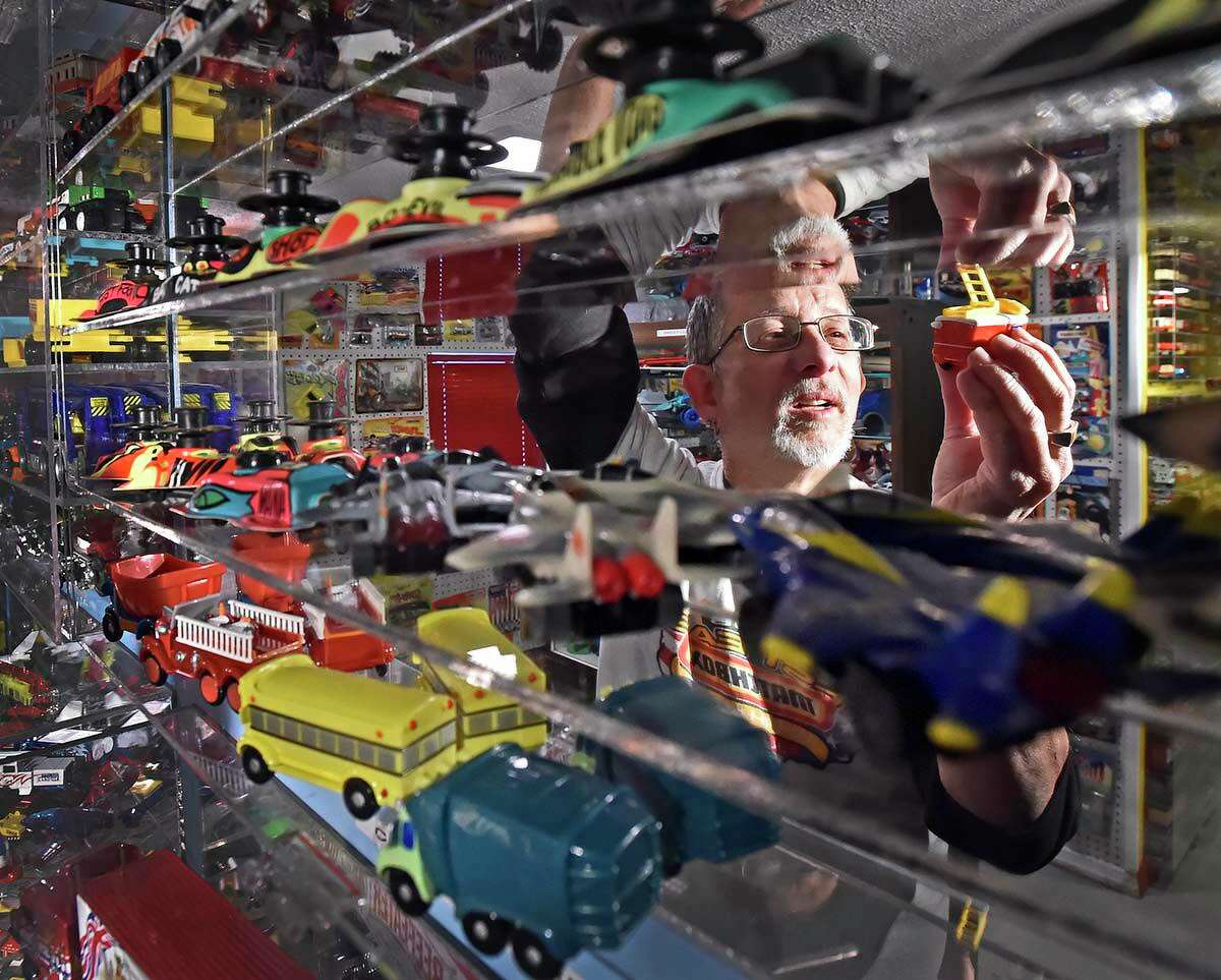 Charlie Mack, surrounded by his collection of Matchbox cars, trucks and toys, looks at a firetruck inspired by the children’s television series Finley the Fire Engine.