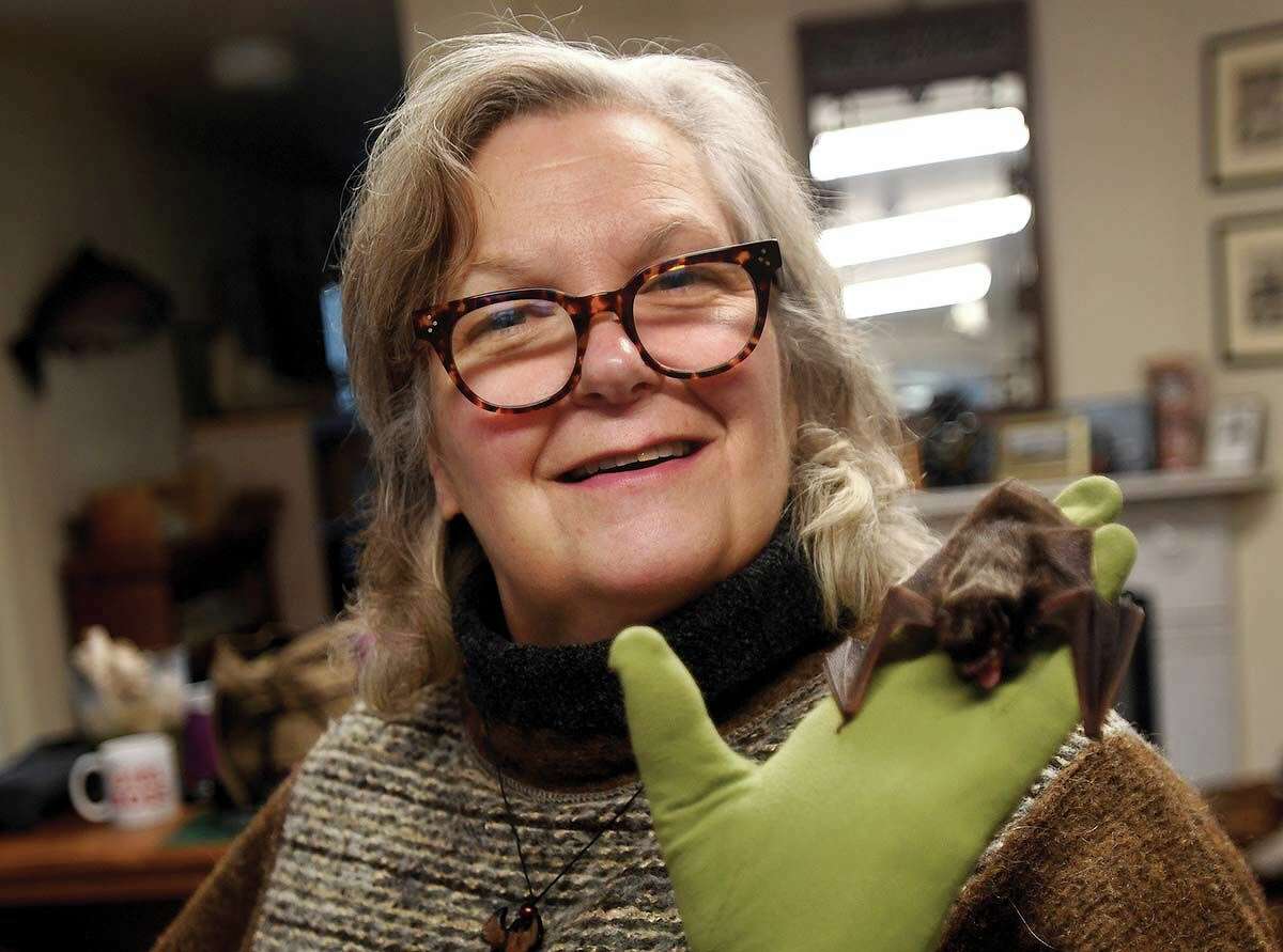 Gerri Griswold, a licensed wildlife rehabilitator, with silver-haired bat Phil at the White Memorial Conservation Center in Litchfield.