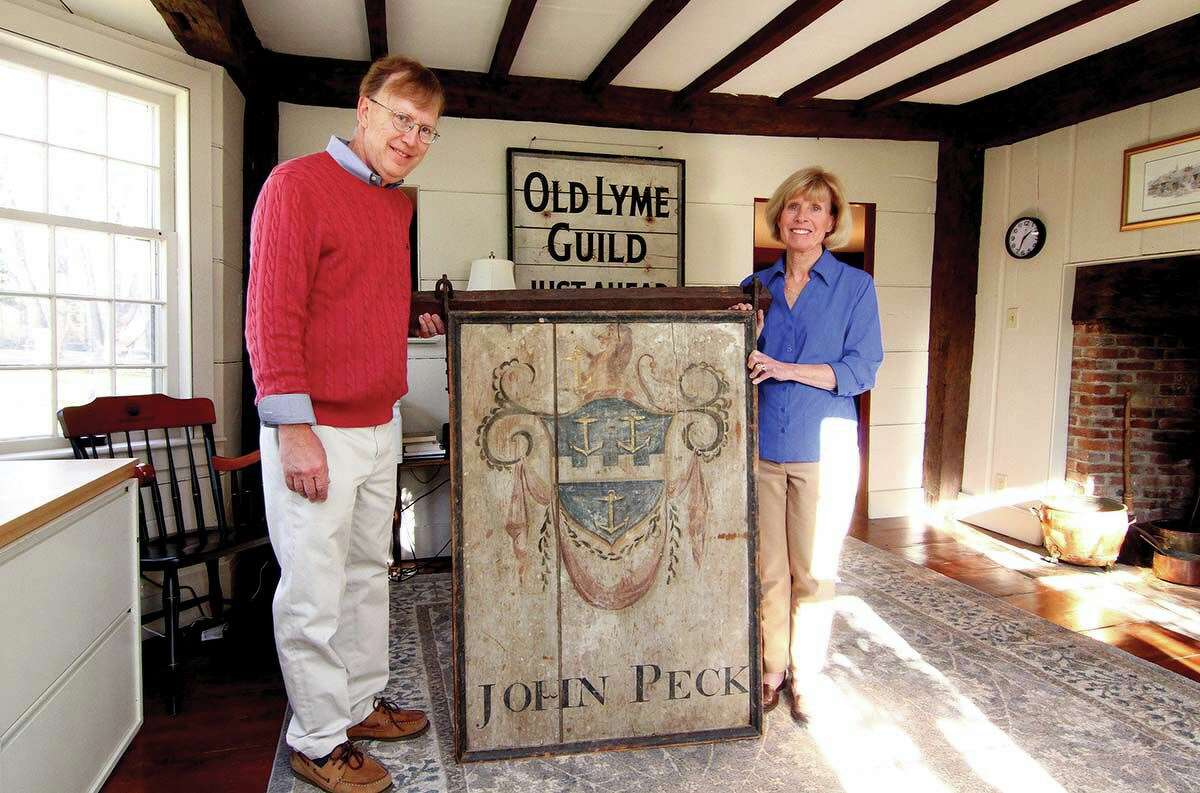 David and Susan Duncan with an original sign from the home when it was a tavern. 