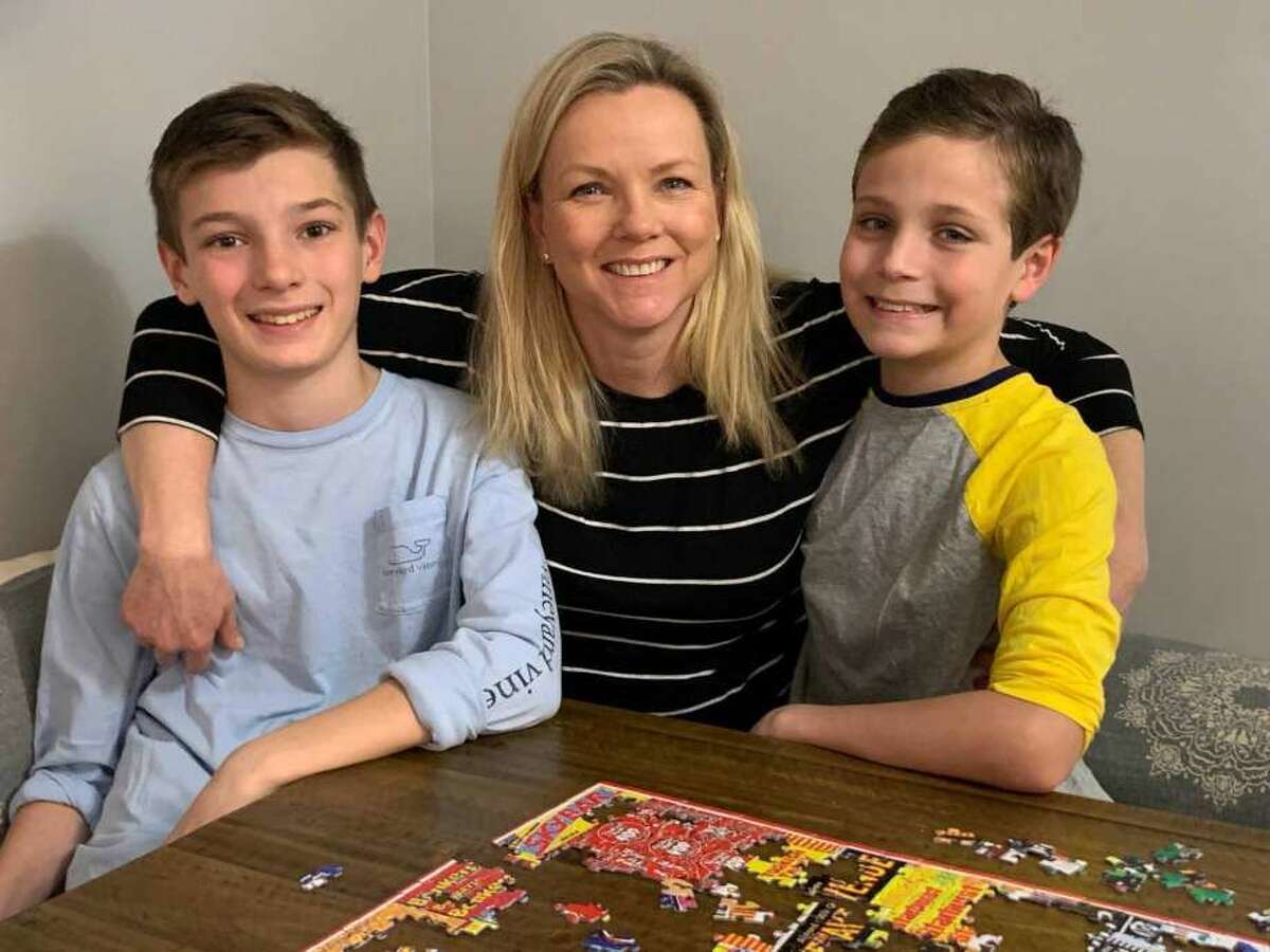Darien resident Kristina Gregory with her sons, Peter, left, 13, and Nathan, 11. Gregory has been recovering from COVID-19. She was separated from her family for over a week quarantined in her room at home.