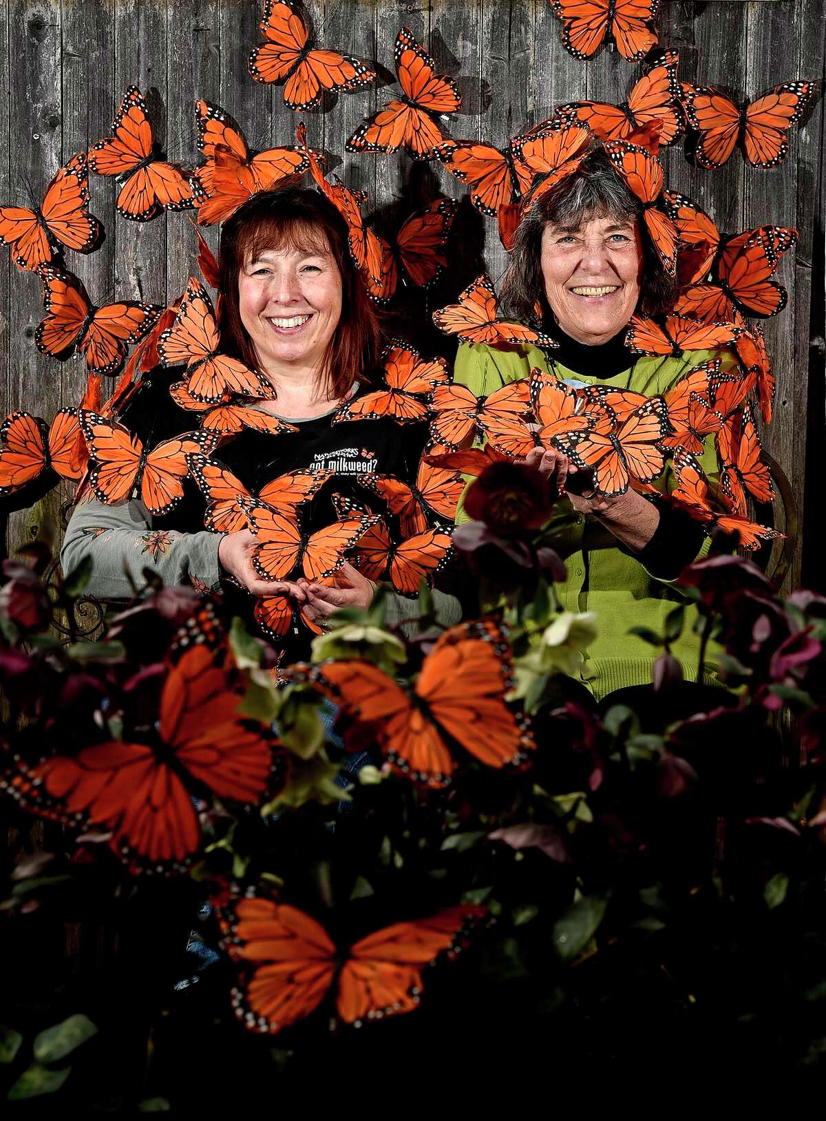 Diane St. John, left, Natureworks store manager, and owner Nancy DuBrule-Clemente have some fun with decorative monarchs at their Northford location.