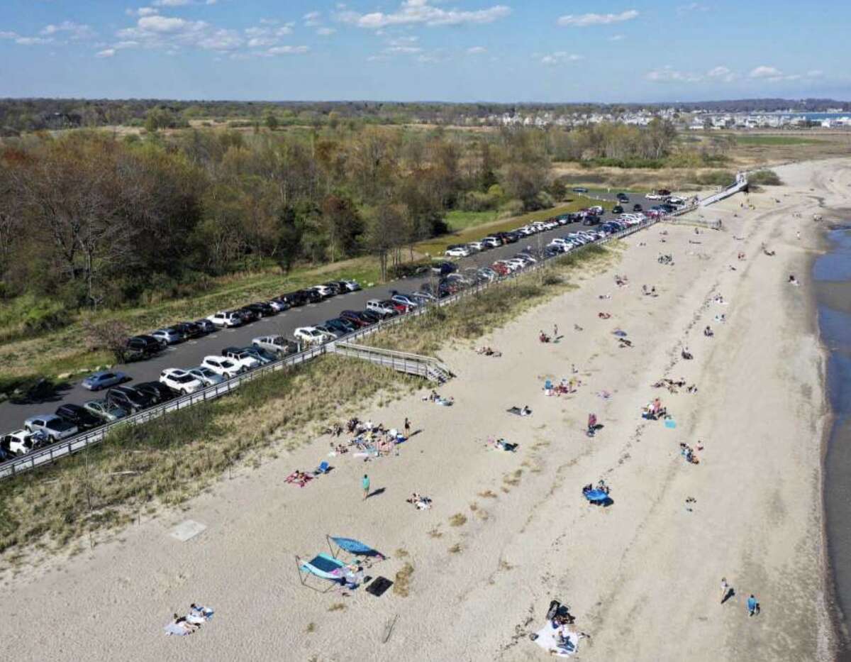Groups of people gather Sunday at Silver Sands State Park in Milford, which was closed to new visitors by the afternoon when the parking lot reached capacity.
