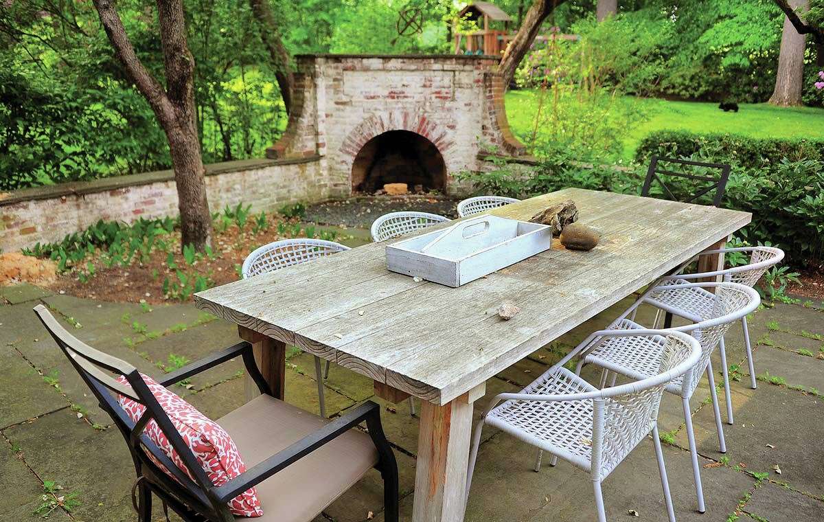 All patio hardscapes, including a fireplace and fountain, are original to the house, and the large wooden table is from Vancouver-based modern furniture maker Article.
