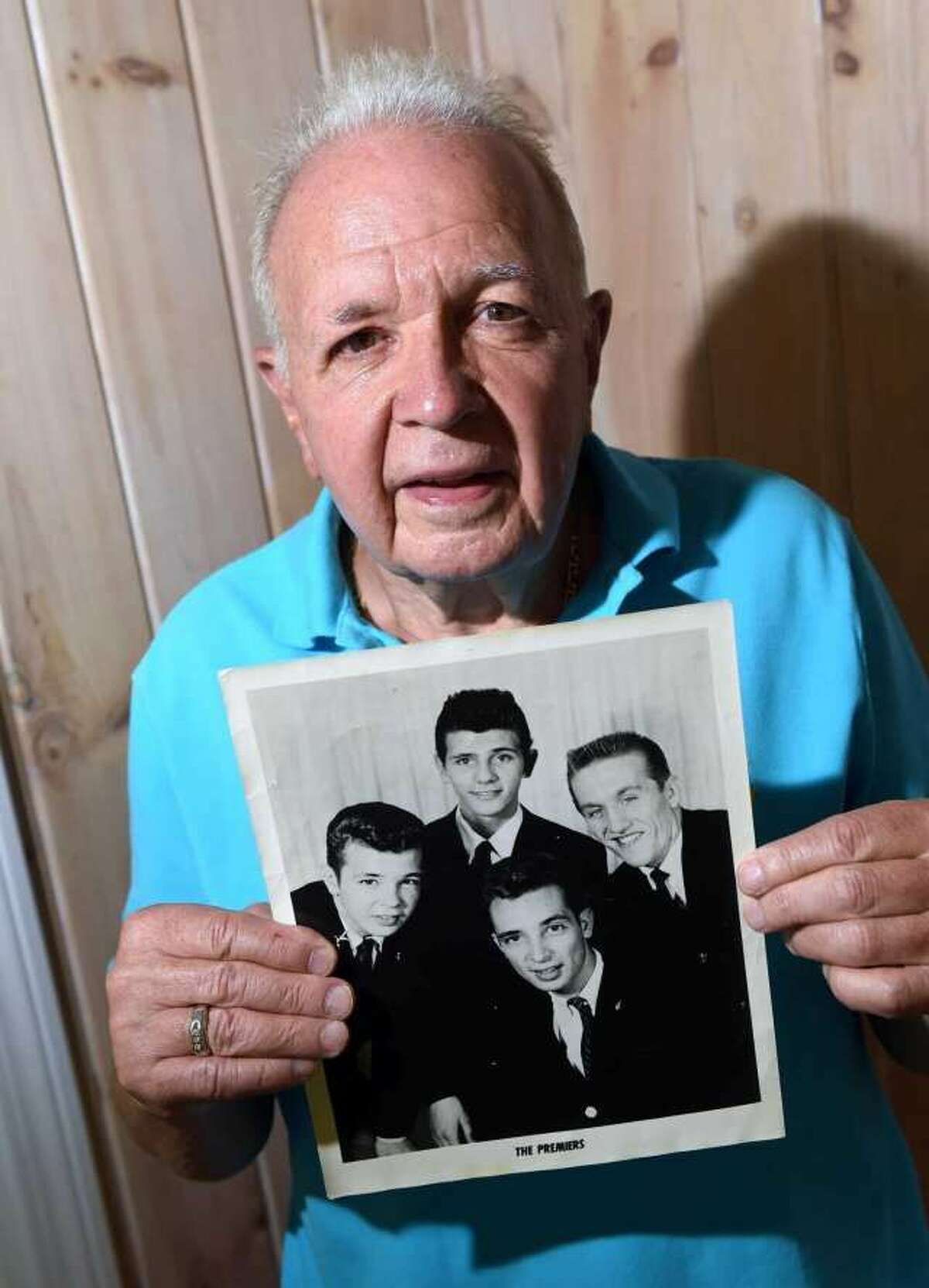 Billy Koob holds an old photograph of the band, The Premiers, at his home in Madison on July 28, 2020. Billy is at left and his brother, Roger, is in front center.  