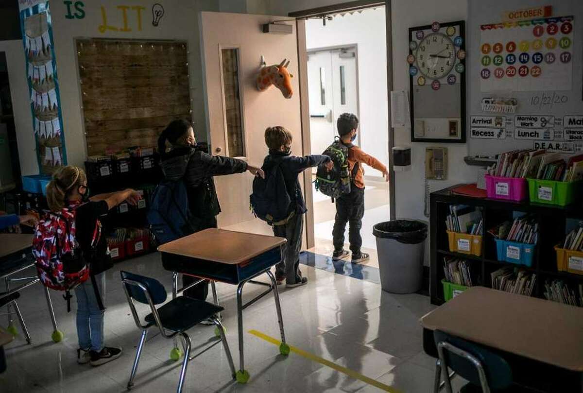 A kindergarten class socially distances while preparing to leave their classroom at Stark Elementary School in Stamford.