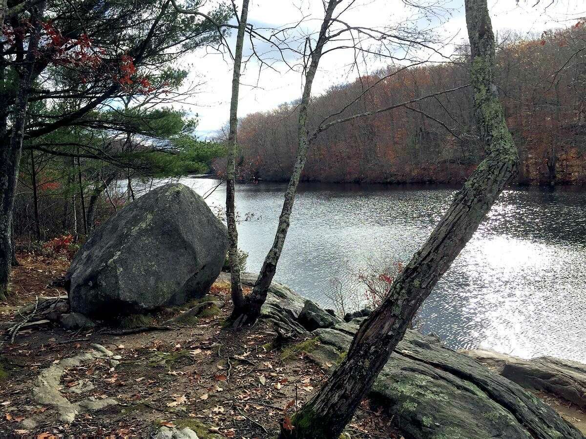 A large boulder stands on the banks of Green Fall Pond.