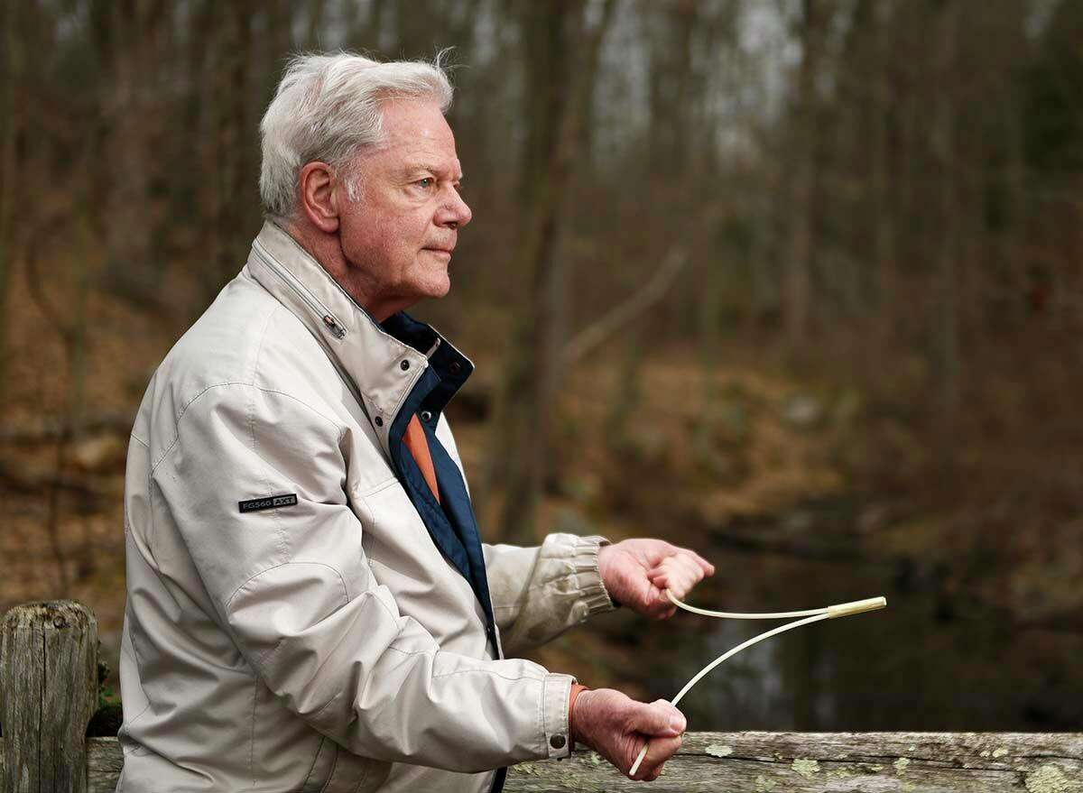 Leroy Bull demonstrates his dowsing technique in the woods of Stamford. Which are you: a dowsing devotee or doubter?