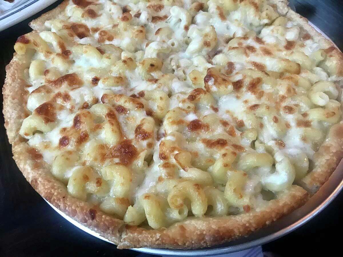 Roberto’s mac and cheese pizza is baked with corkscrew-shaped cavatappi pasta and a medley of cheeses.
