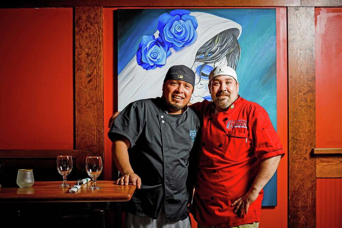 Chefs Oscar Yanez (in black) and Chris Herbert.