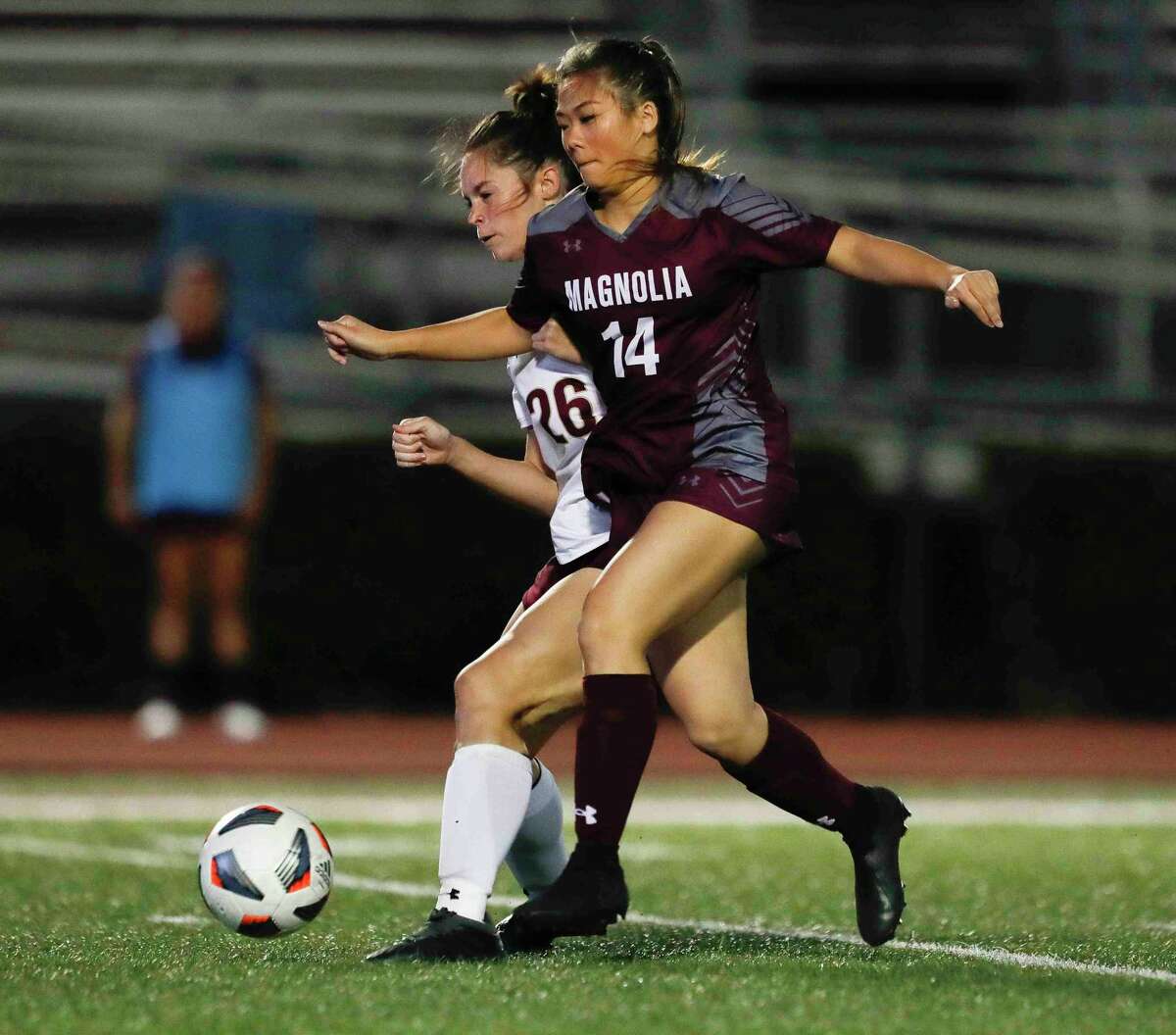 Magnolia’s Tate Perugini (14) dribbles the ball against Magnolia West’s Abigail Garcia (24) in the first period of a high school soccer match at Magnolia High School, Friday, March 4, 2022, in Magnolia.