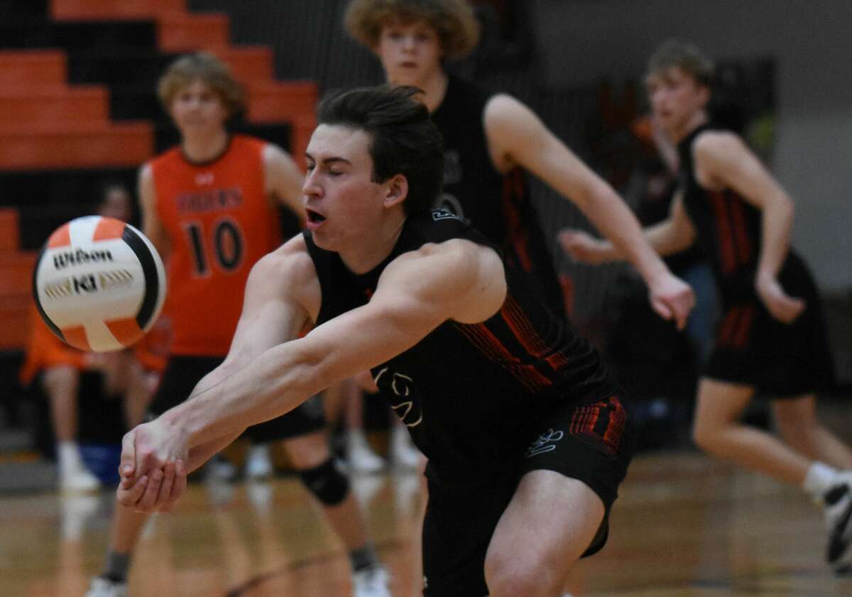 Edwardsville's Jacob Geison reaches to receive a serve during the first game against O'Fallon on Tuesday inside Lucco-Jackson Gymnasium in Edwardsville.
