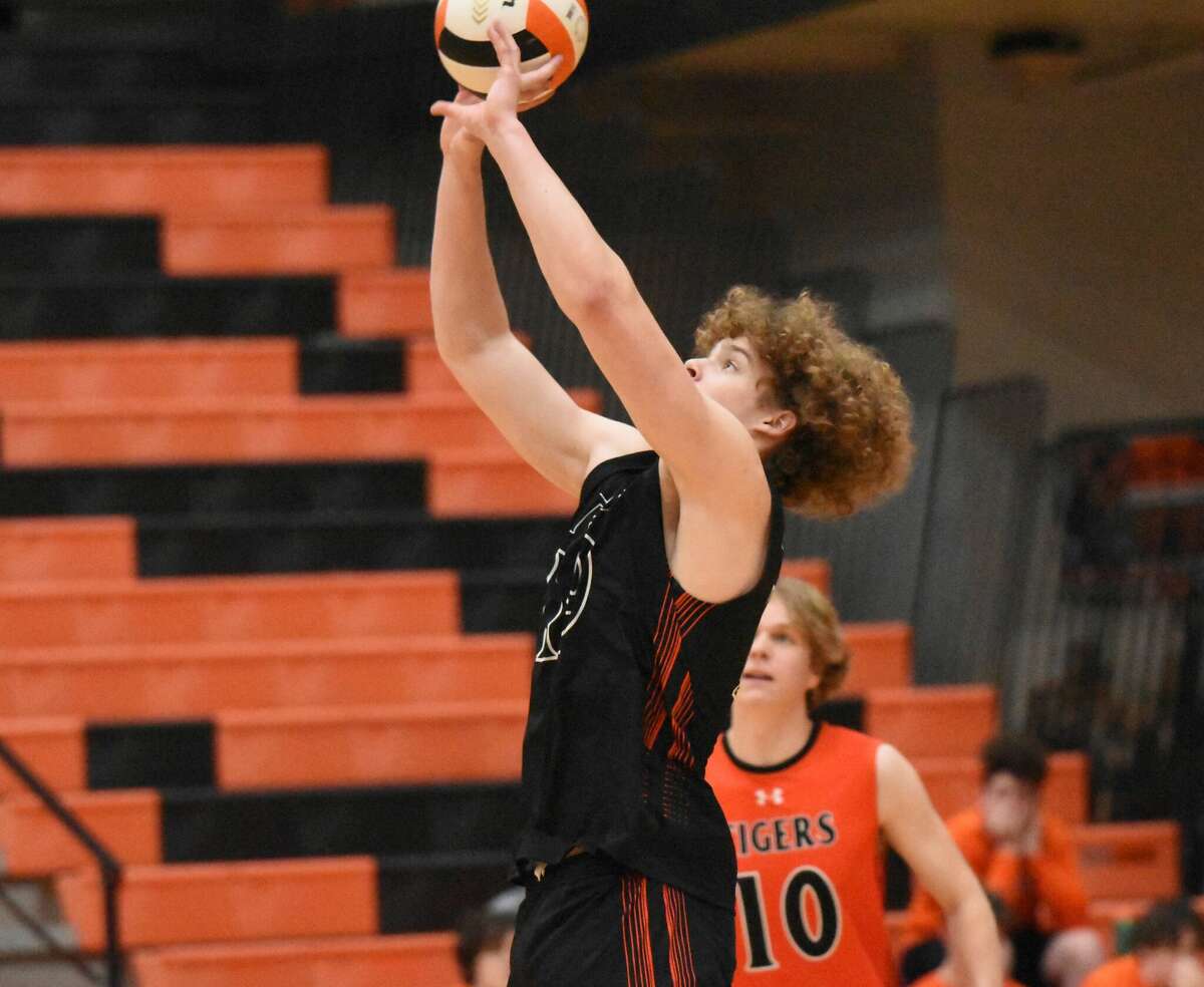 Edwardsville's Evan Reid keeps the play alive during the first game against O'Fallon on Tuesday inside Lucco-Jackson Gymnasium in Edwardsville.