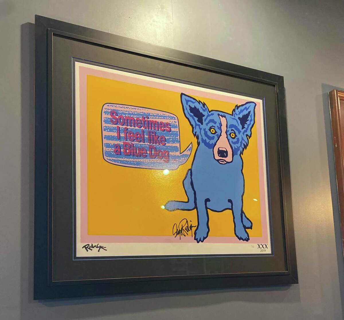 At Roux, a “Blue Dog” portrait by Louisiana artist George Rodrigue hangs on the wall, based on the Cajun legend of the loup-garou, a mythical werewolf-like creature.