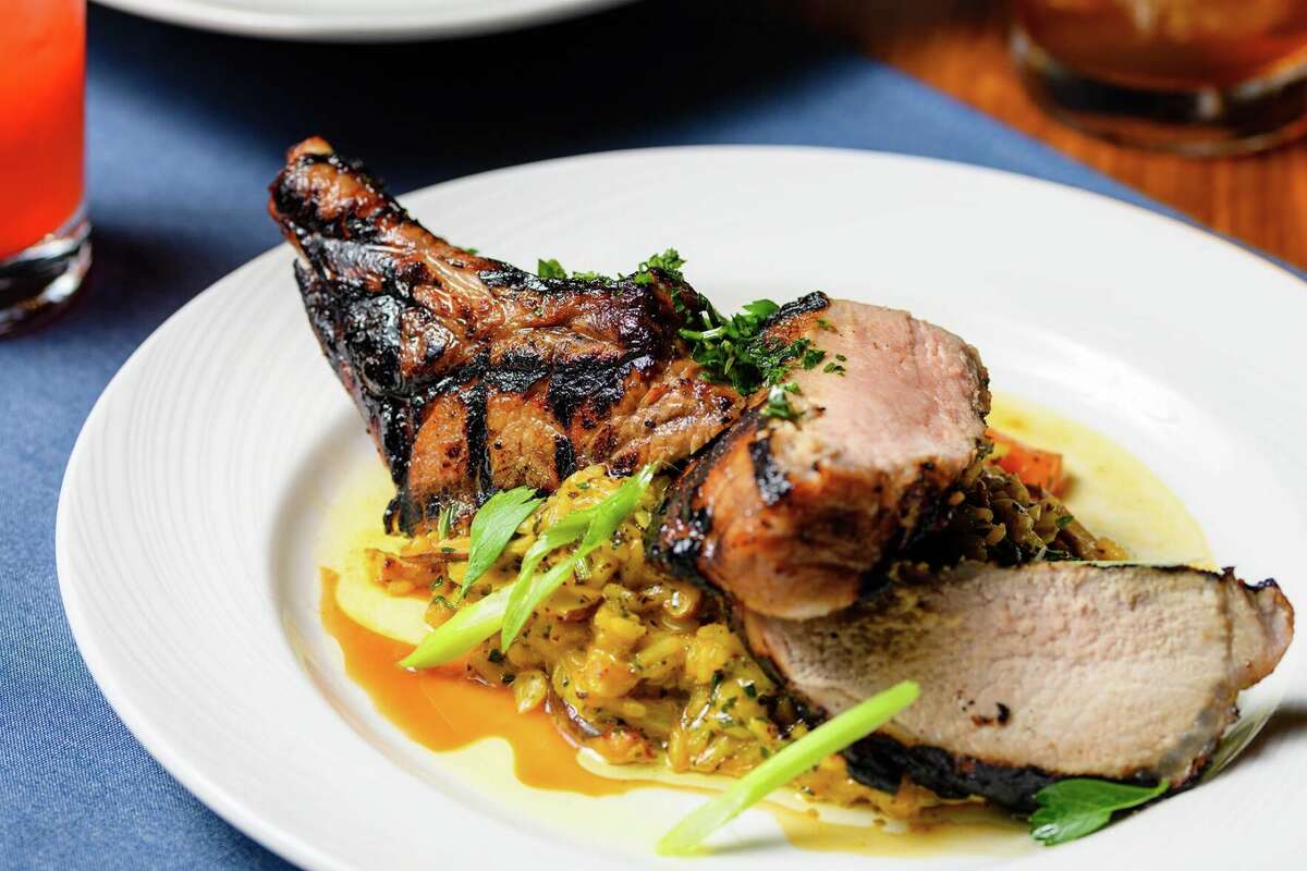 A double-cut cider-brined pork chop comes with Frenched ribs and a bed of heirloom carrots, carrot risotto and wild mushrooms, from Cotton Hollow Kitchen in South Glastonbury.