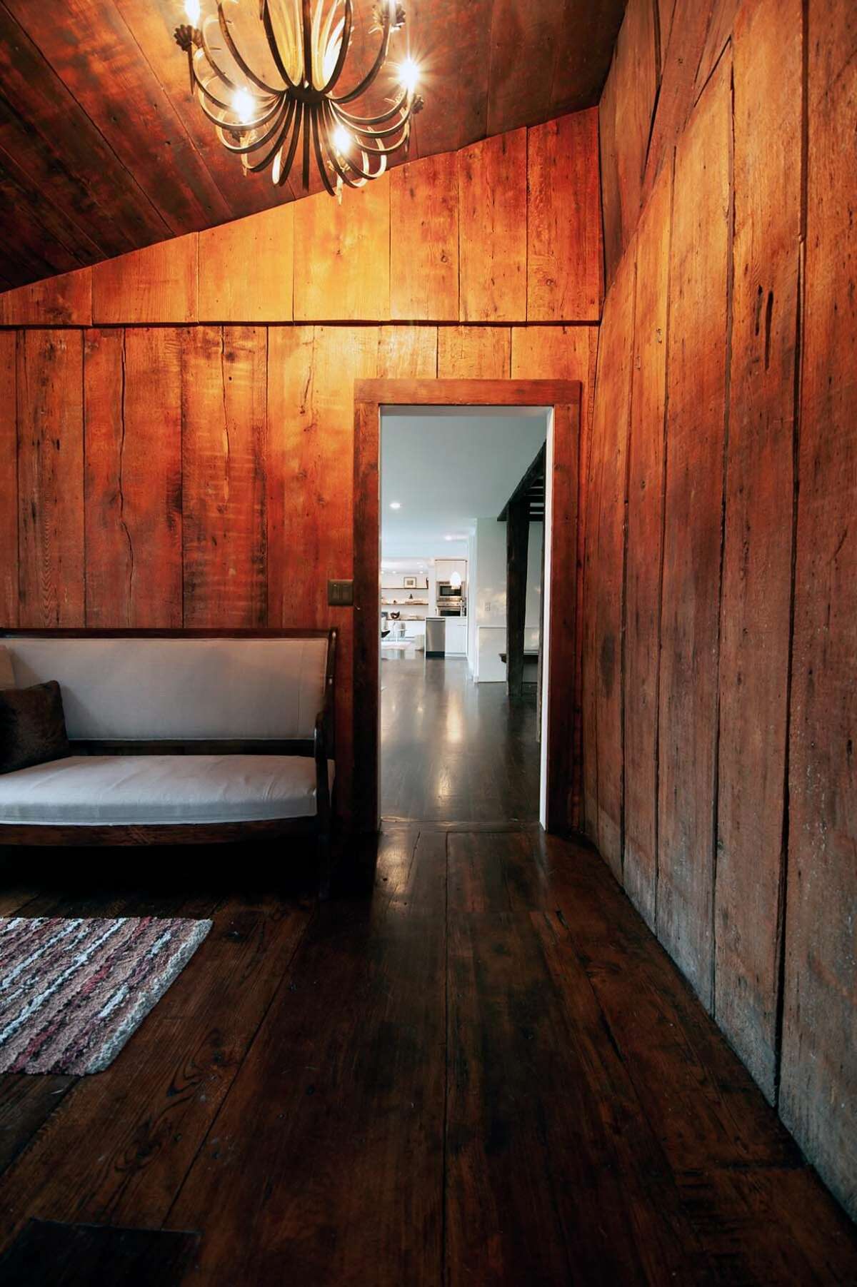With signs of use and weathering, wide wood planks were preserved to show the farmhouse’s 18th-century character.