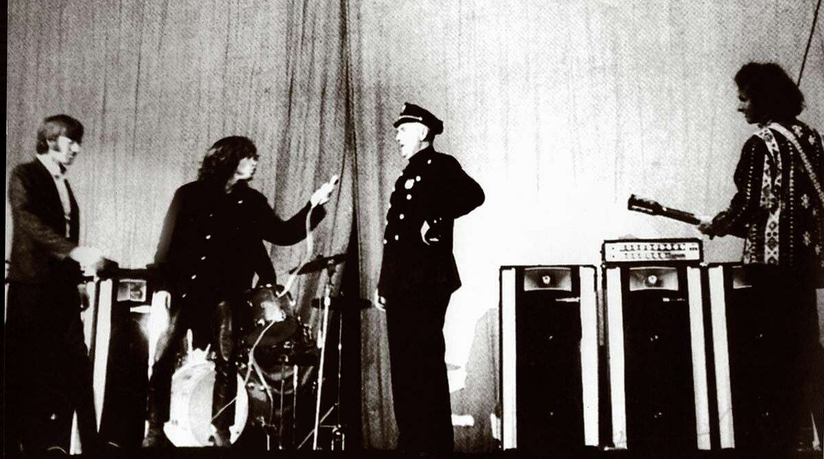 Jim Morrison of The Doors, second from left, is confronted by police Lt. James Kelly at the New Haven Arena in 1967 just before his arrest.