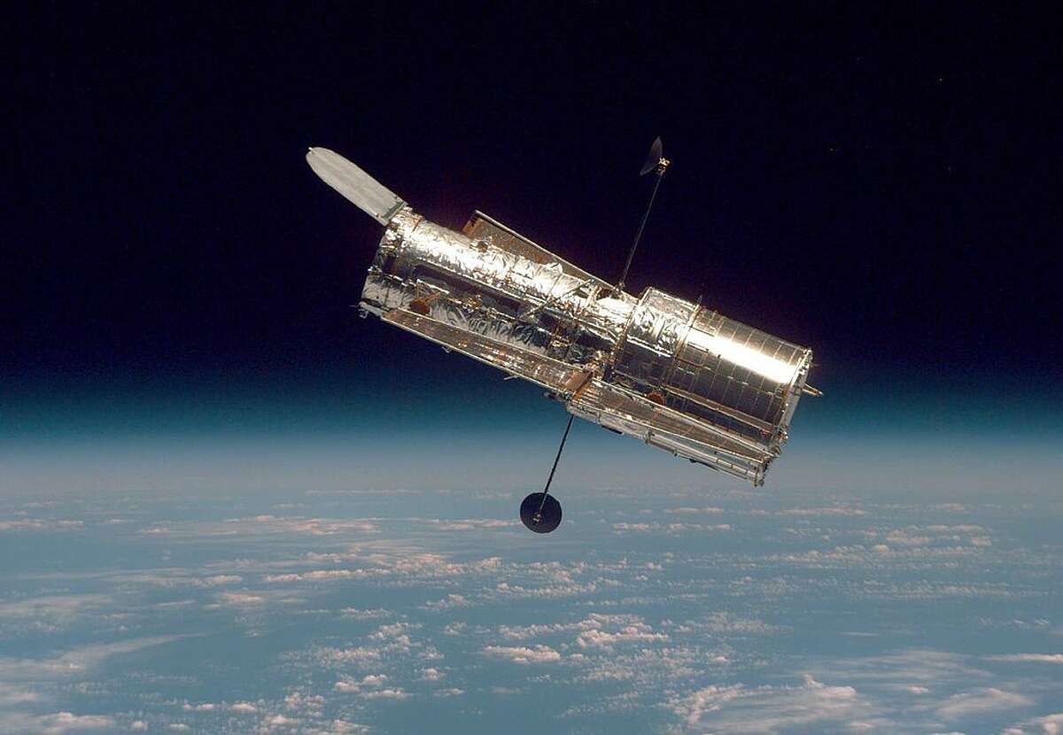 In this handout from the National Aeronautical Space Administration (NASA), the Hubble Space Telescope drifts through space. (Photo by NASA via Getty Images)