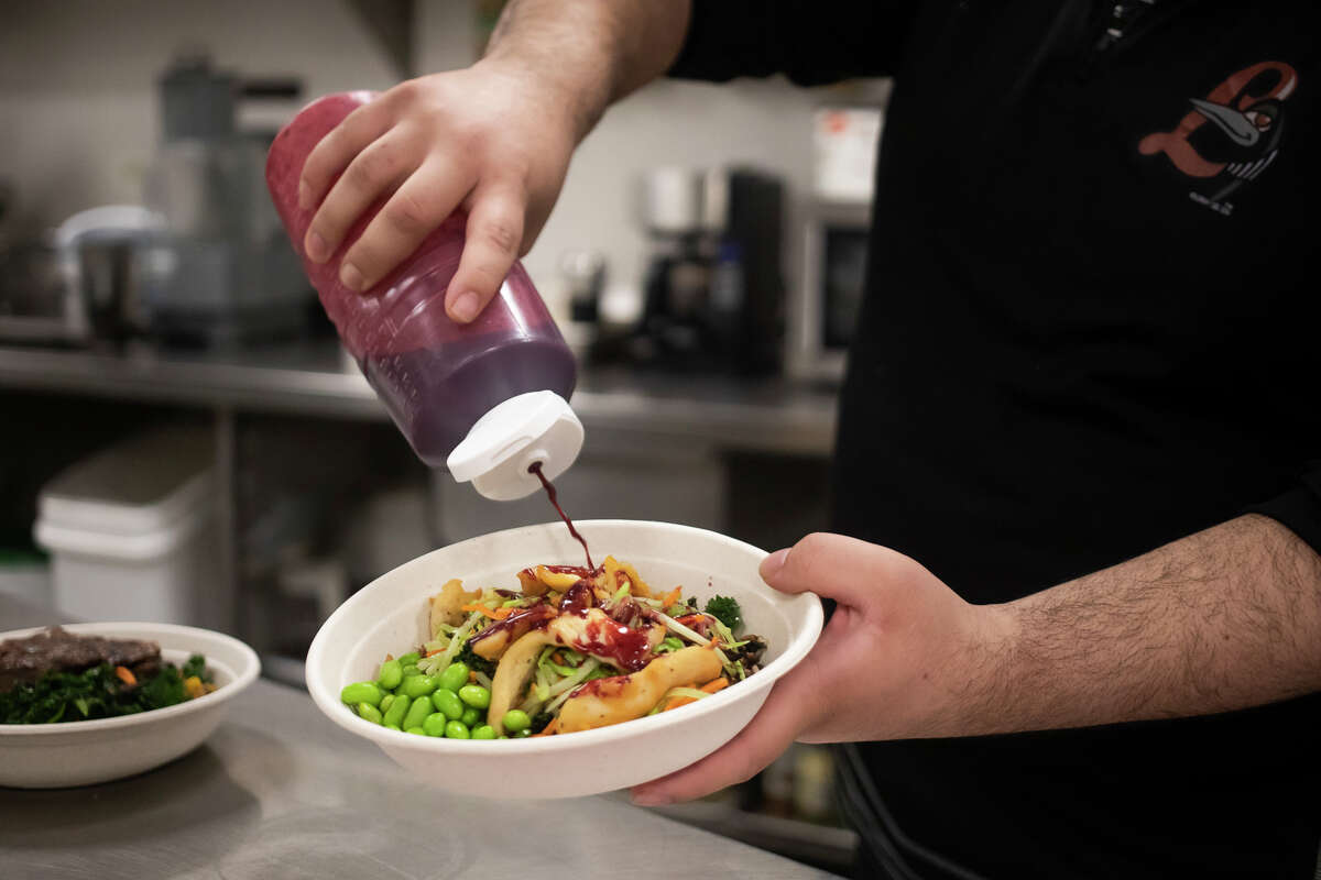 Loons Executive Chef Carlos Valles prepares a power bowl, one of several new menu items that will be offered at Dow Diamond this season, Friday, March 25, 2022 inside the facility's kitchen.