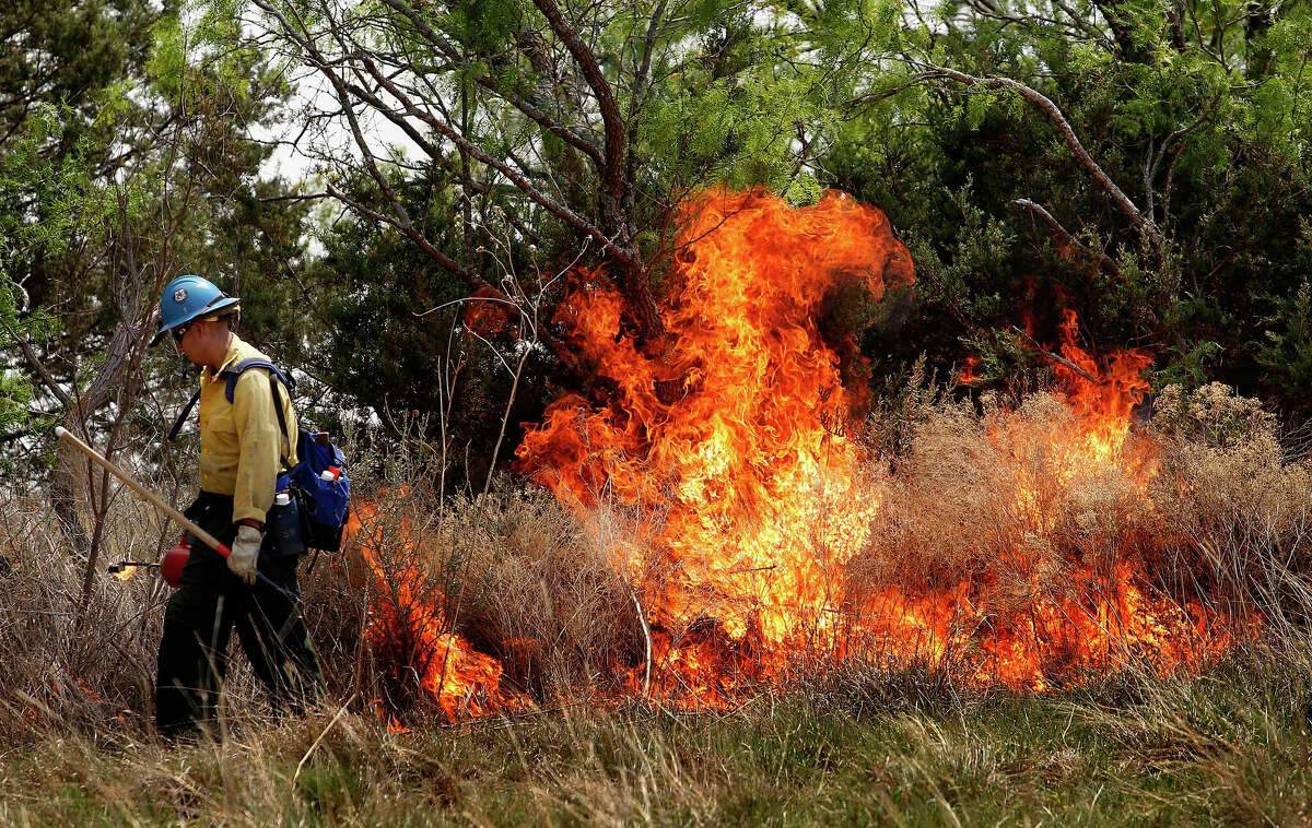 Federal firefighter Jesus Palencia sets a back fire while fighting a running wildfire on April 19, 2011 in Strawn, Texas. Dozens of area homes have been destroyed in the wildfires that have been fueled by dry conditions, high winds, and low humidity.