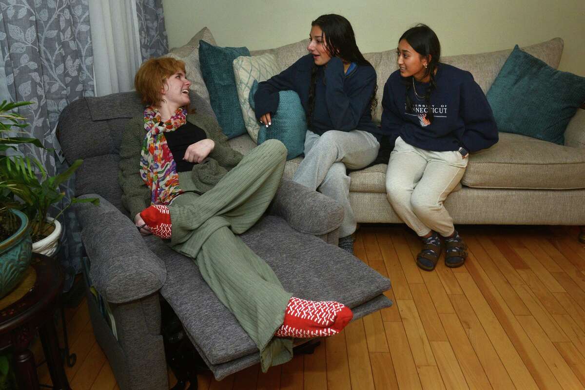 Eva Houlihan meets with her friends, Ava Messina and Nhuja Shrestha on Eva’s first night back home in Woodbury, Conn. Oct. 5, 2021. Eva has been in the hospital recovering from a car accident in Southbury last April that left her boyfriend dead.